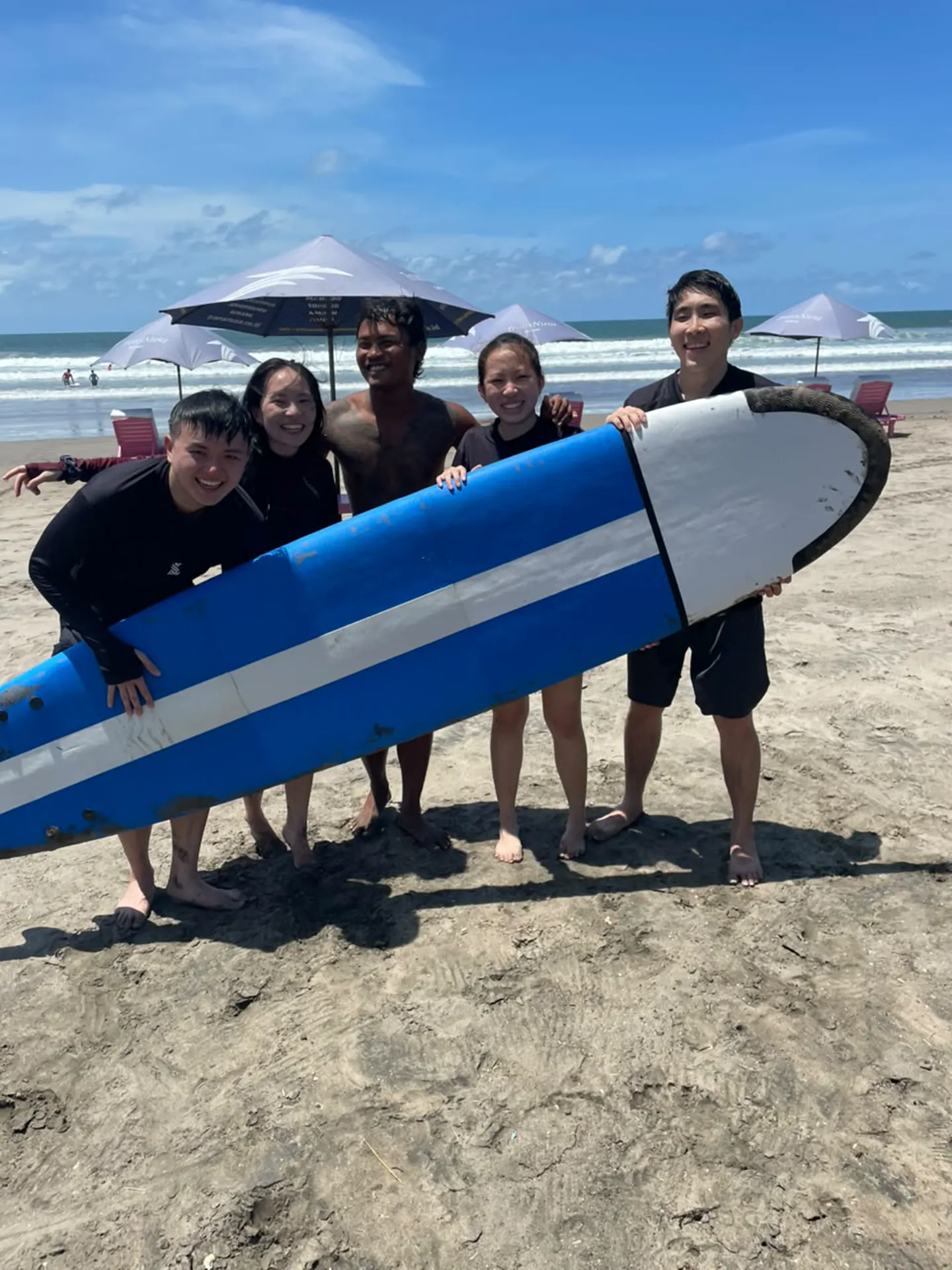 Ocean Surf Lesson student with surfboard